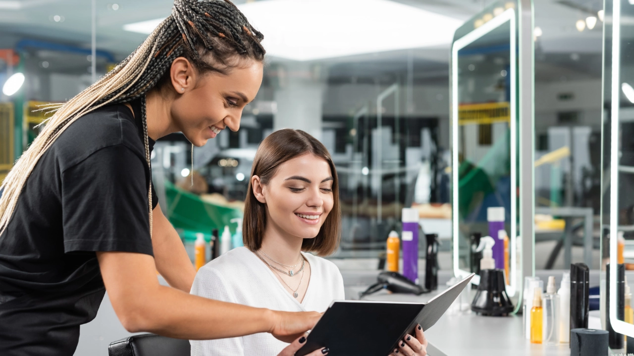 young woman looking at options with a technican in a salon