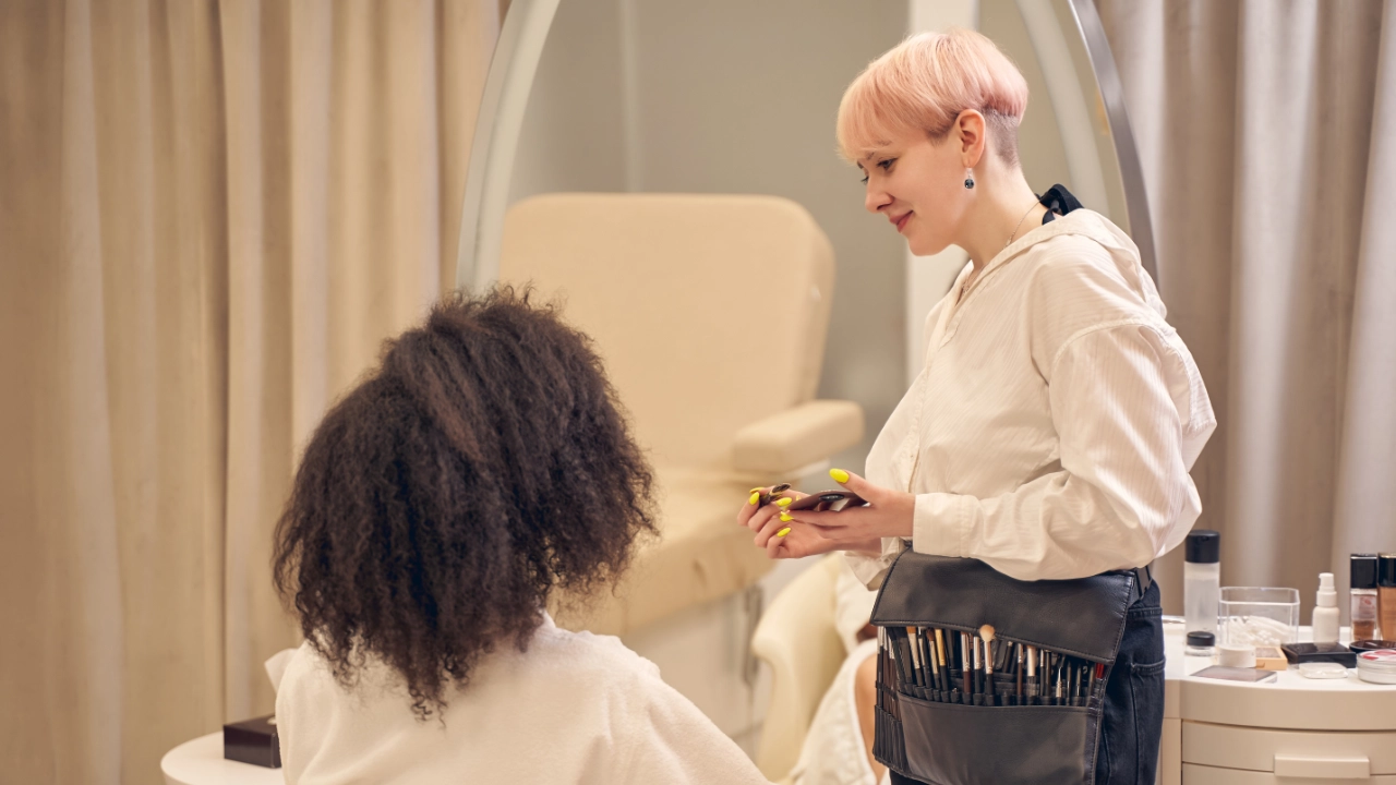 young woman getting her makeup done by a makeup artist